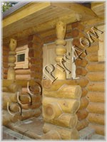 Крыльцо деревянного дома с резными столбами